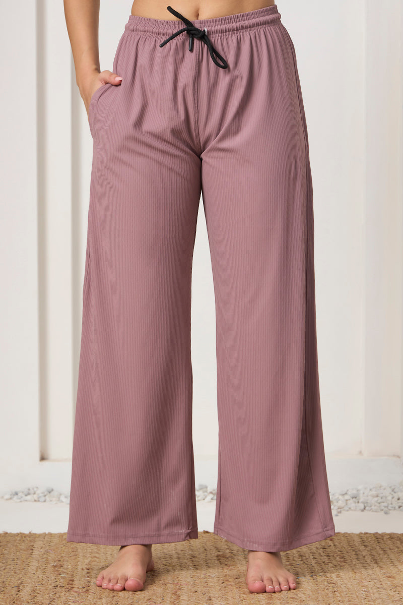 Close up of drawstring waistband on mauve ribbed pyjama pants