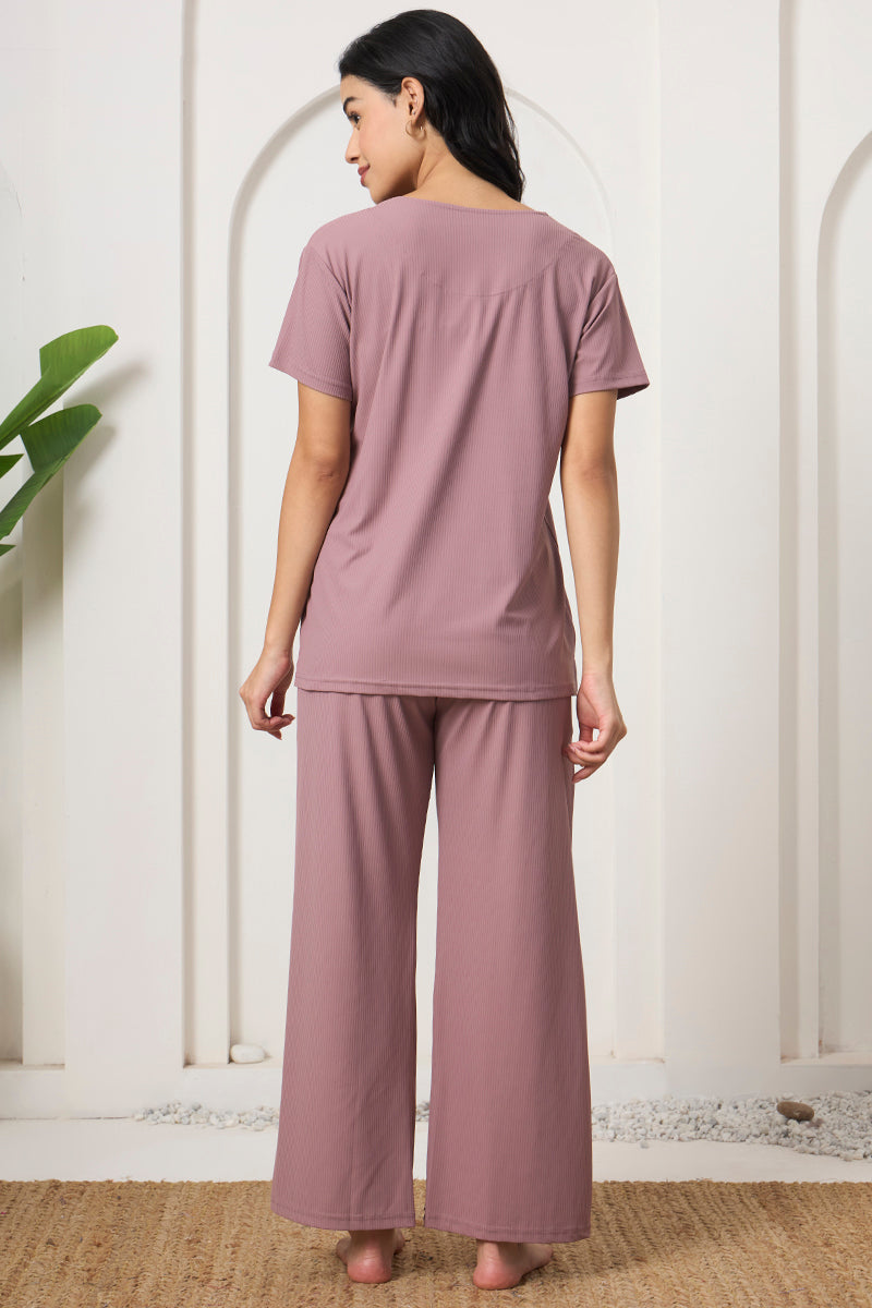 Back view of a woman wearing a mauve ribbed pyjama set