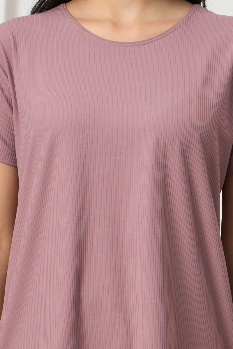 Close up of ribbed fabric and round neckline on mauve pyjama top