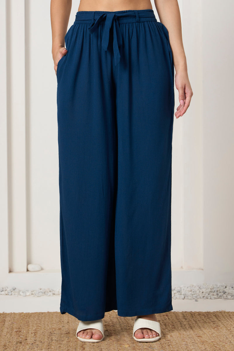 Close up of the tie waist and pocket detail on the teal wide leg pants