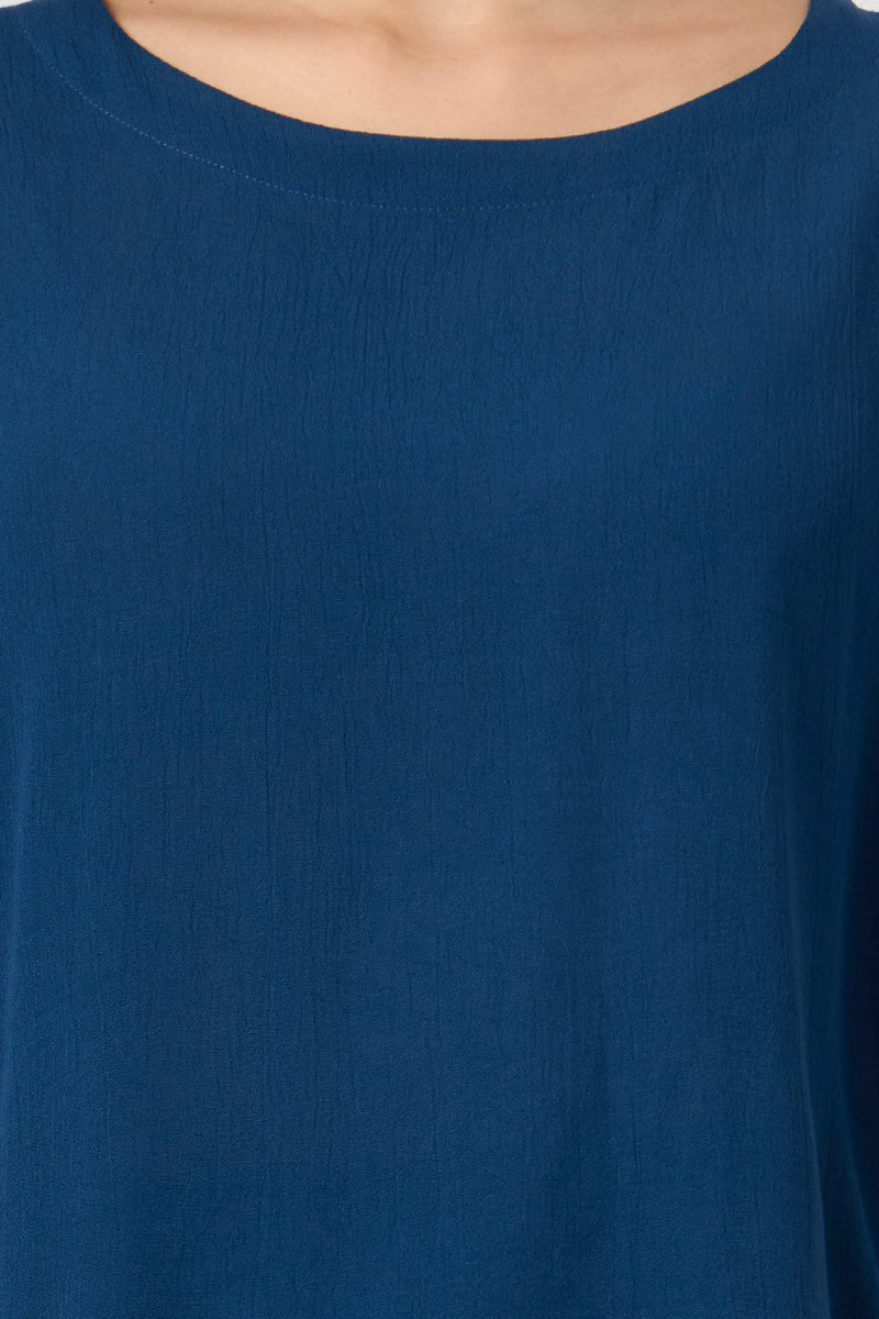 Close up of the round neckline and fabric texture on the teal top