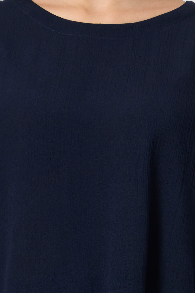 Close up of the round neckline and fabric texture on the navy top