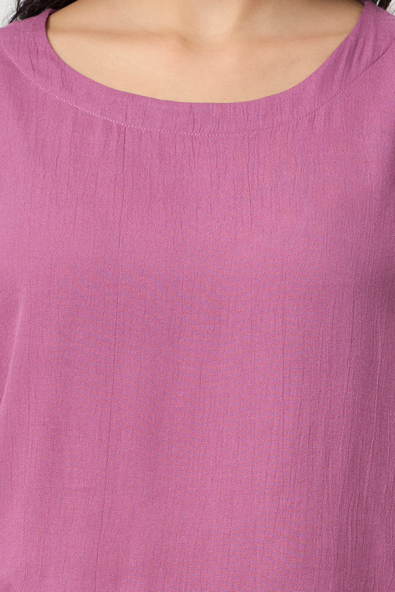 Close up of the round neckline and fabric texture on the mauve top