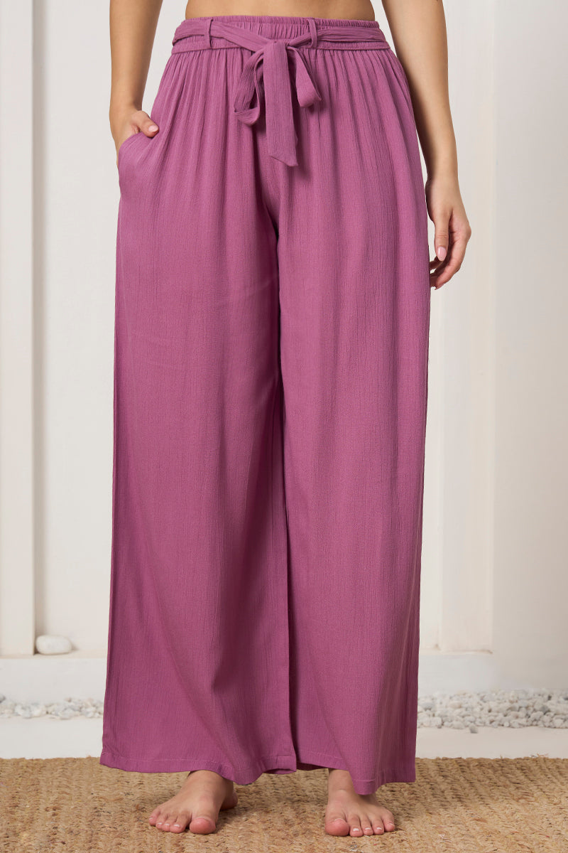 Close up of the tie waist and pocket detail on the mauve wide leg pants