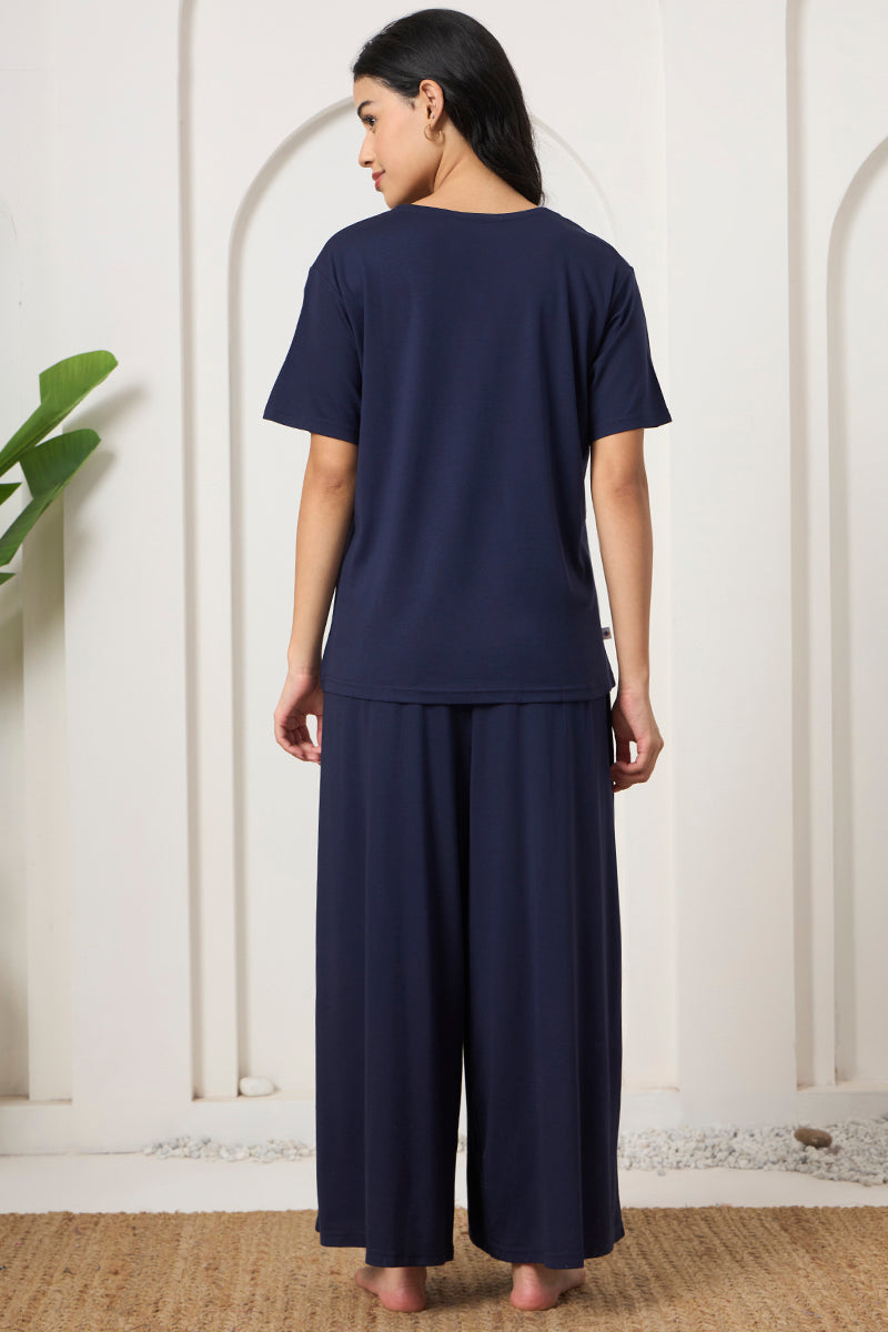 Back view of a woman wearing a navy t-shirt and wide leg pants set
