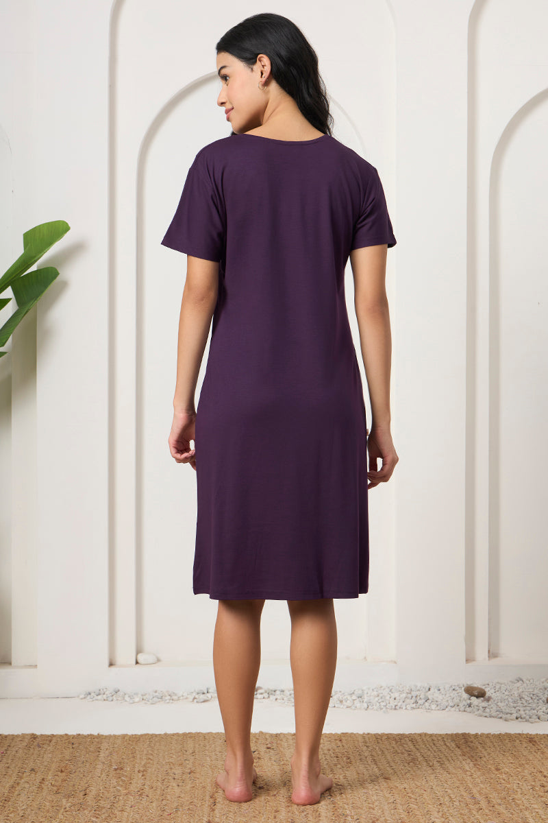 Back view of a woman wearing a purple short sleeve nightdress