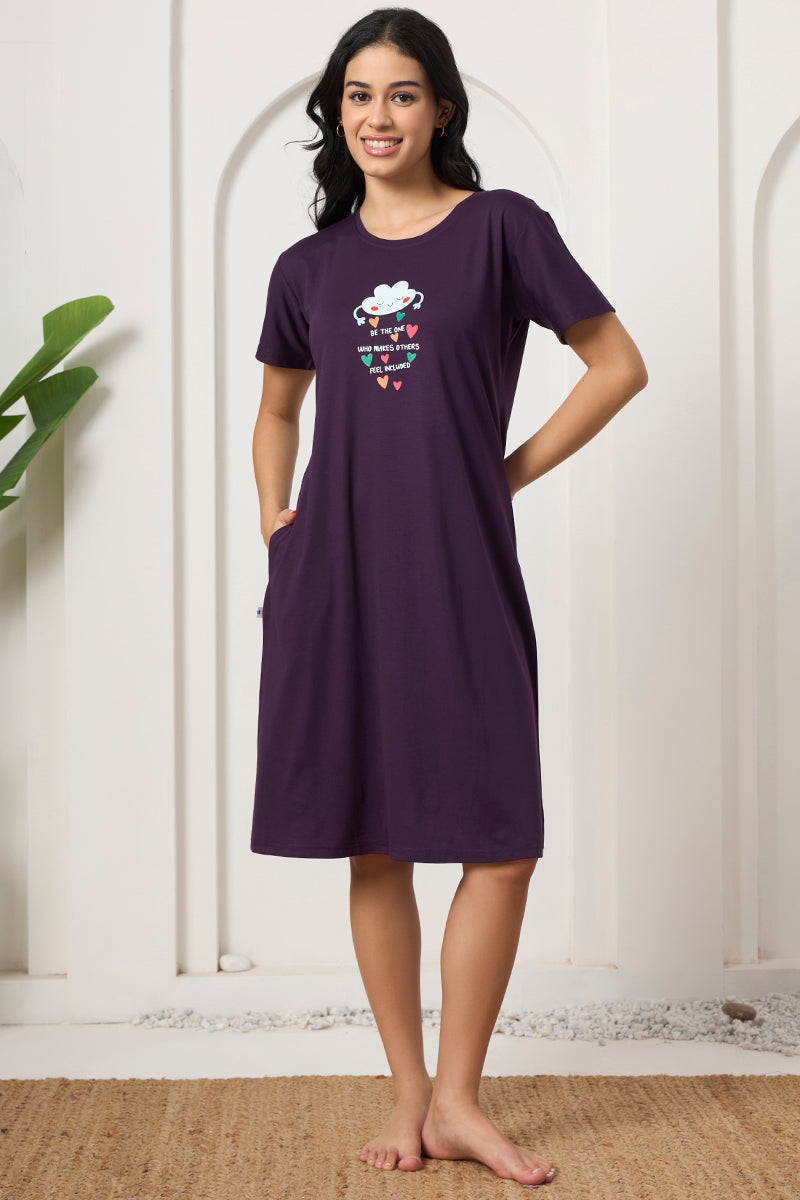 Woman smiling with hand on hip in a purple graphic print nightdress
