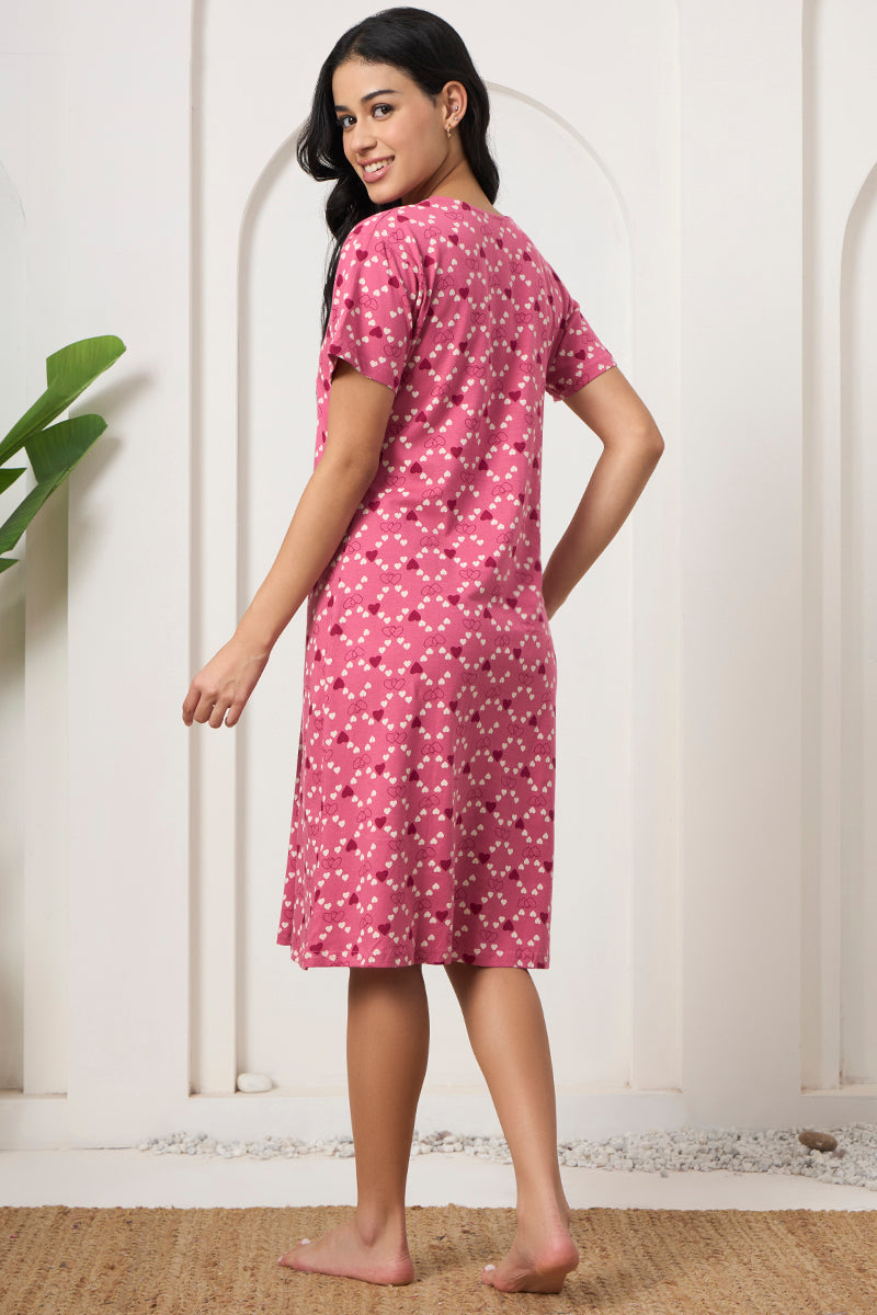 Back view of a woman wearing a pink heart print nightdress