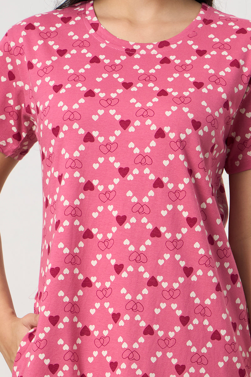 Close up of the heart print detail on the pink nightdress