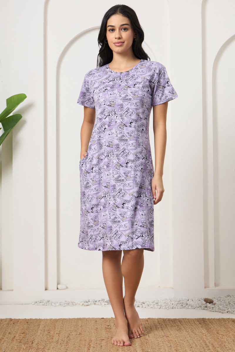 Woman standing in a lavender comic strip print nightdress