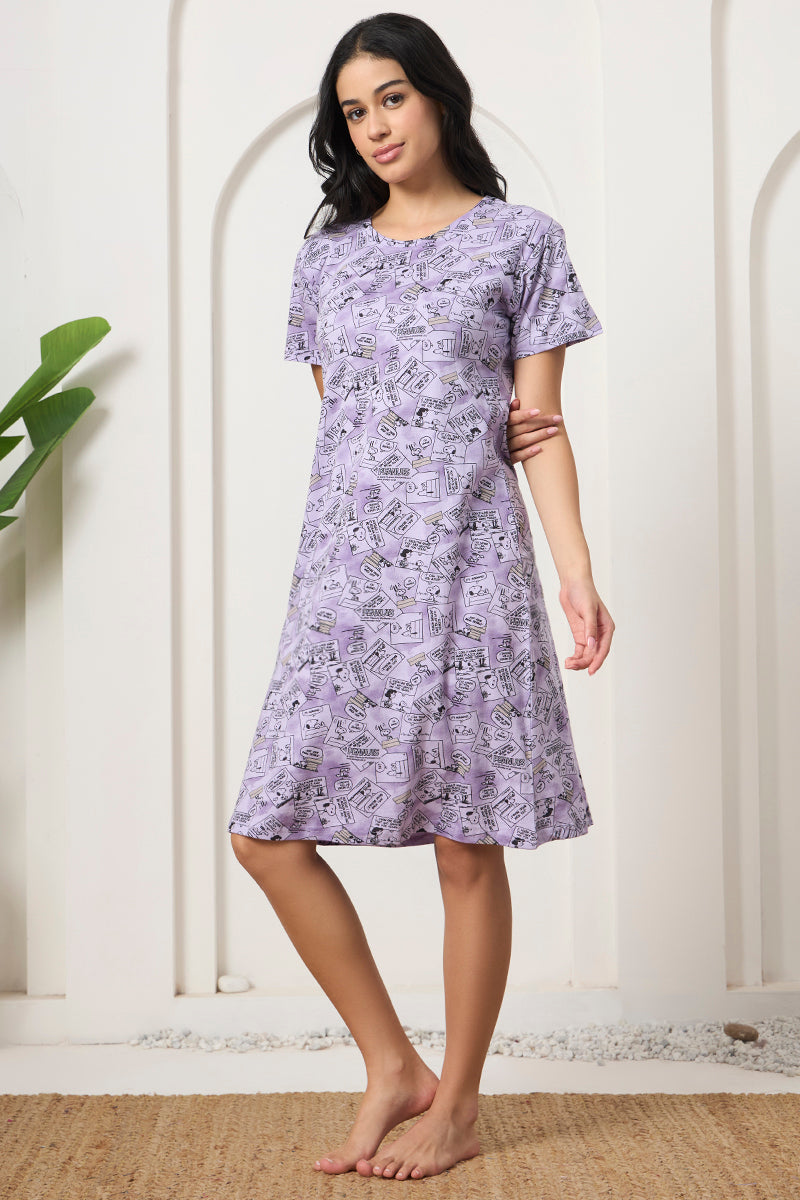 Woman posing with hand behind back in a lavender comic print nightdress