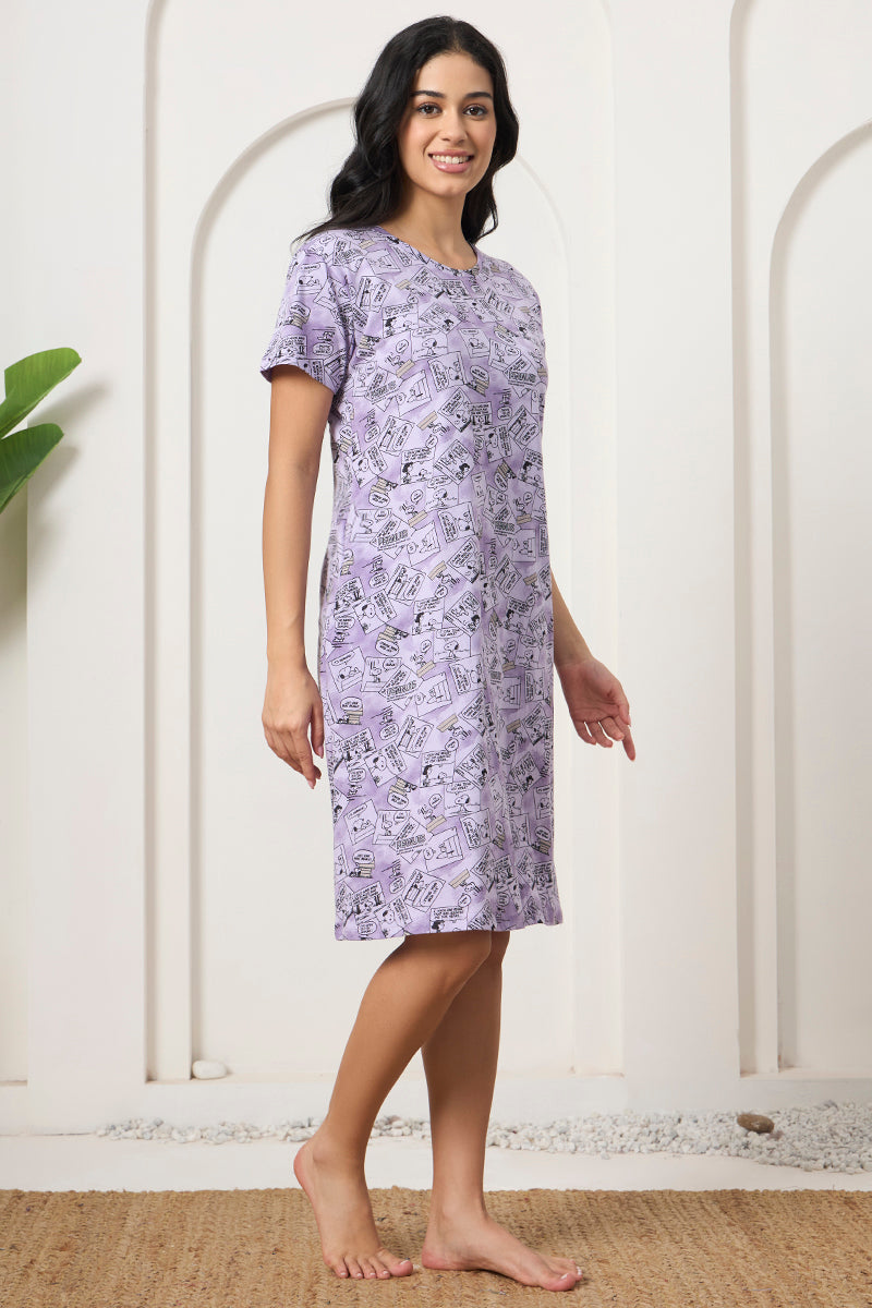 Woman standing sideways in a lavender comic strip print nightdress