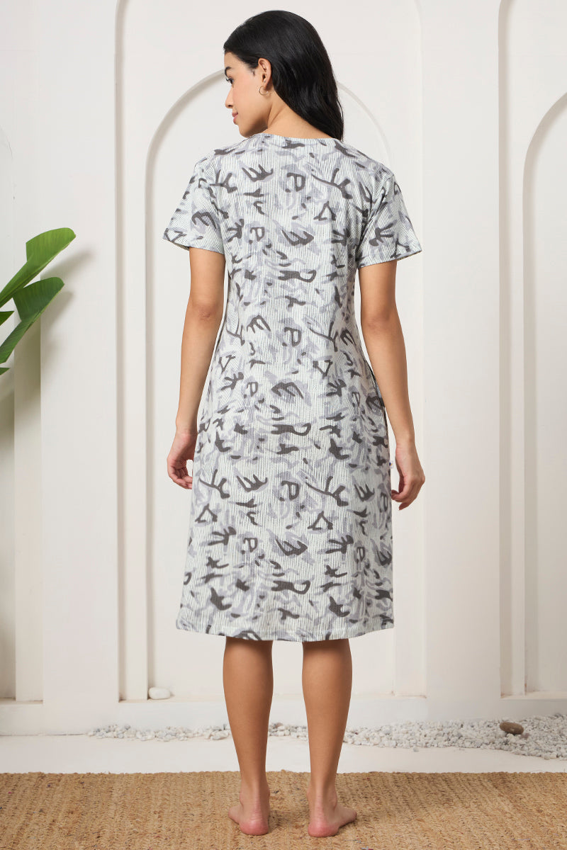 Back view of a woman wearing a grey abstract print nightdress