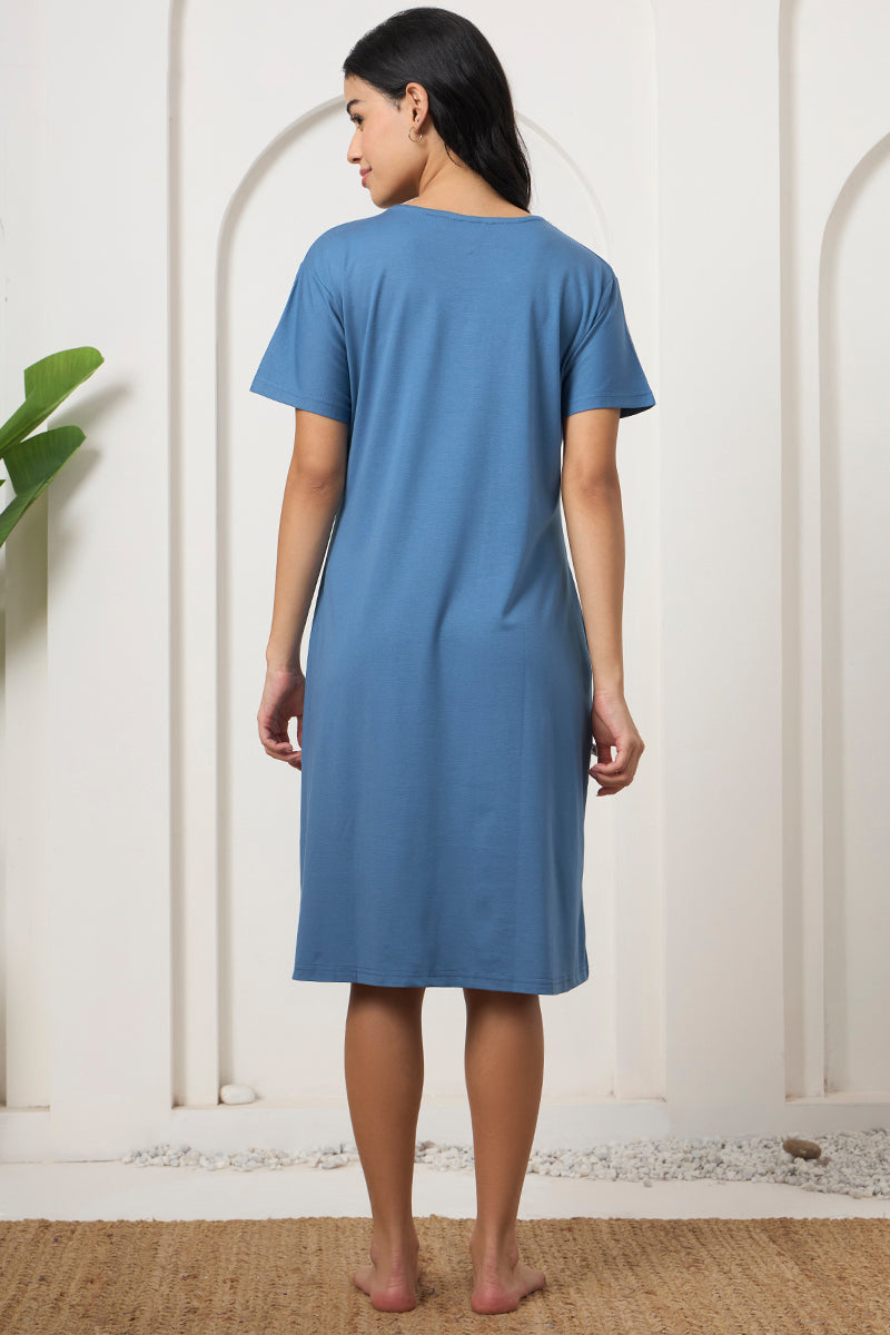 Back view of a woman wearing a blue round neck nightdress