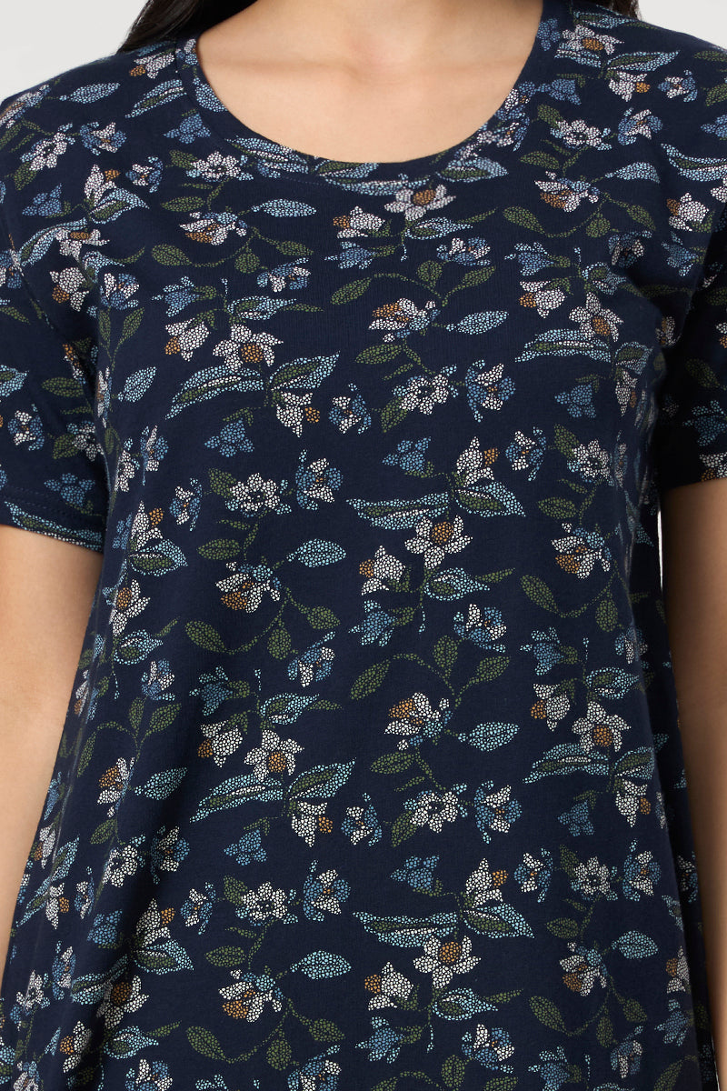 Close up of the round neckline and floral print detail on the navy nightdress