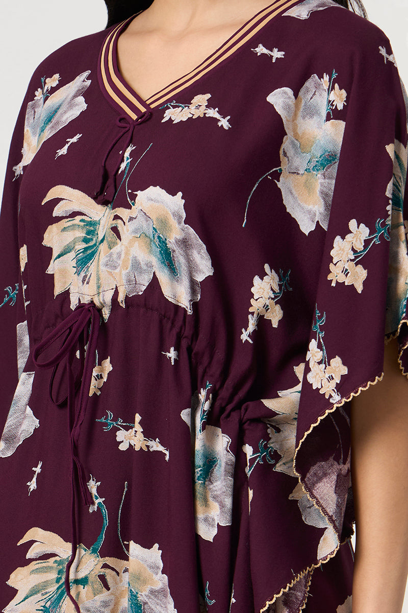 Close up of the tie neck and drawstring waist on the wine floral kaftan