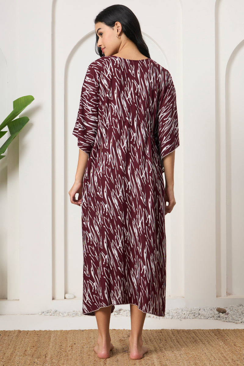Back view of a woman in a wine abstract print kaftan