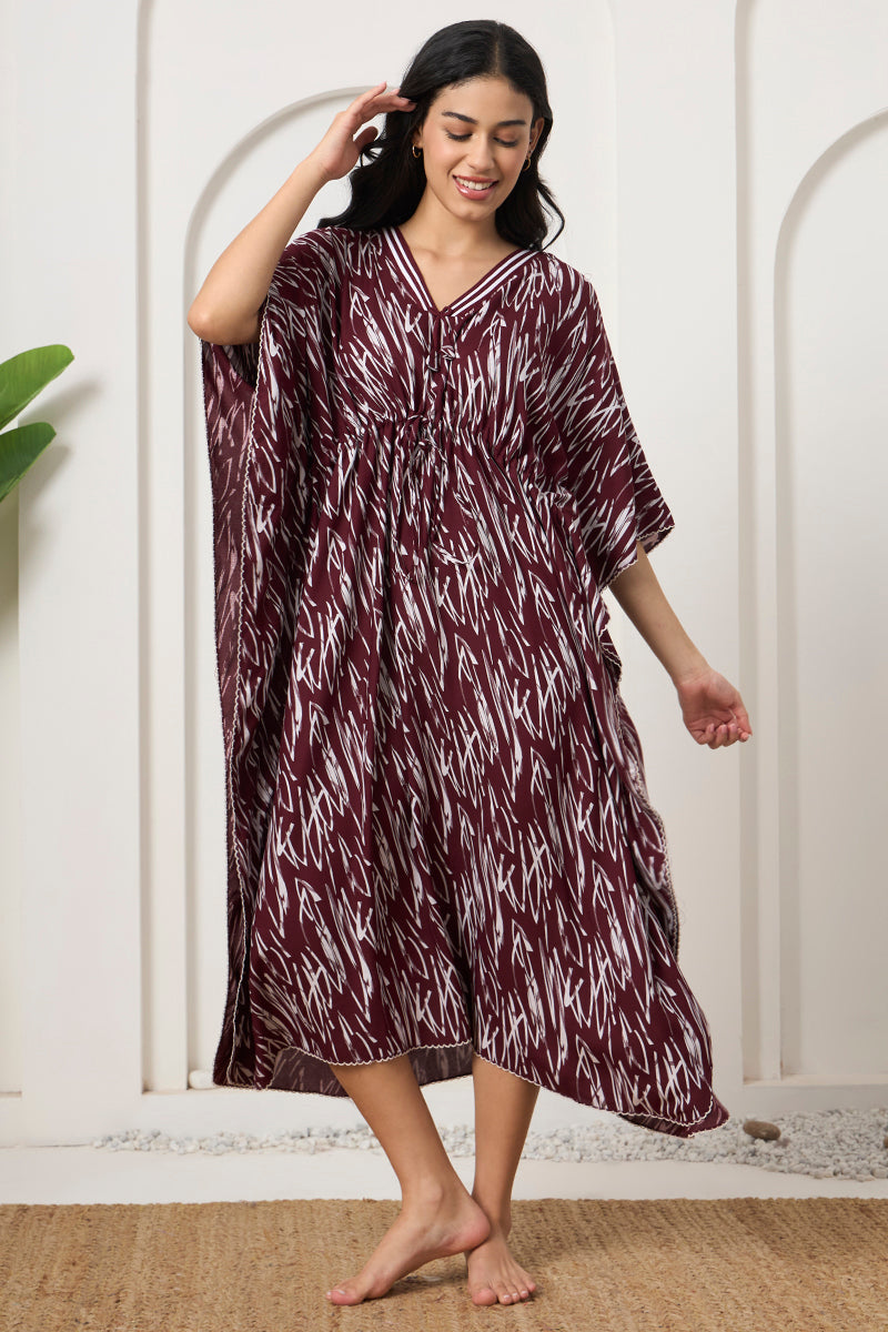 Woman smiling in a wine abstract print kaftan