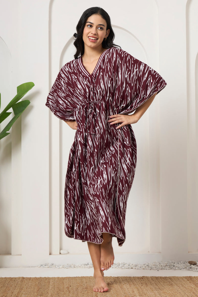 Woman standing with hand on hip, wearing a wine printed kaftan