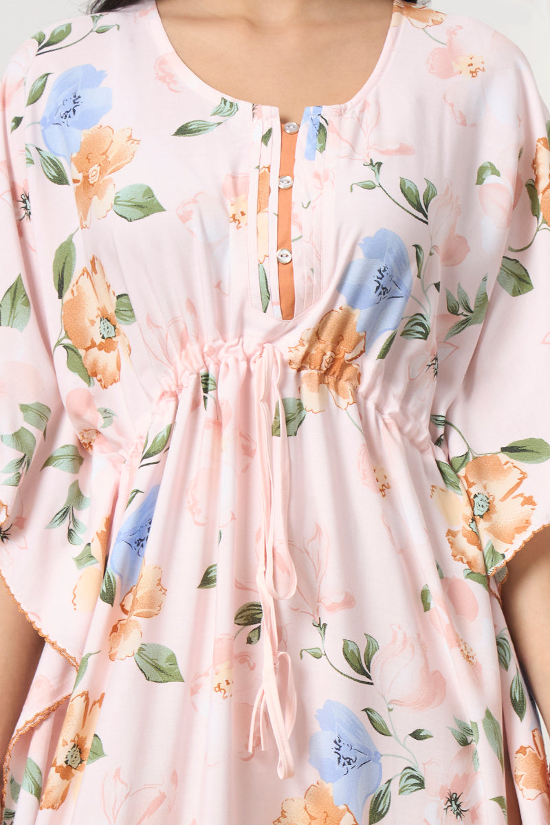 Close up of the button placket and drawstring waist on the pink floral kaftan