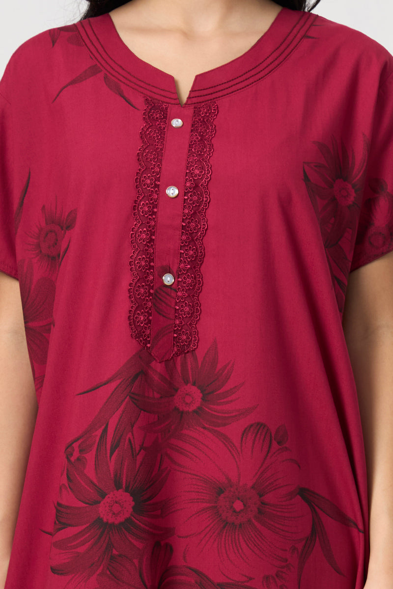 Close up of the lace trim and button detail on the maroon nightgown neckline