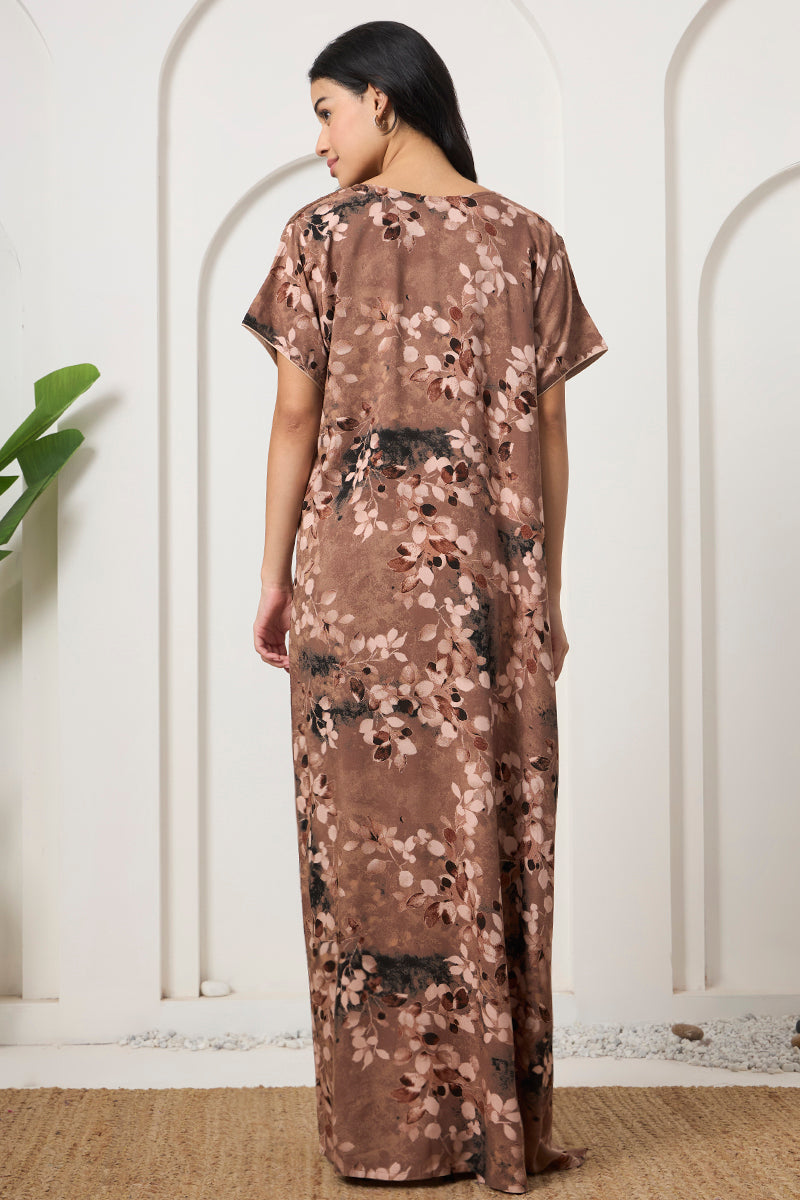 Back view of a woman in a brown floral maxi nightgown