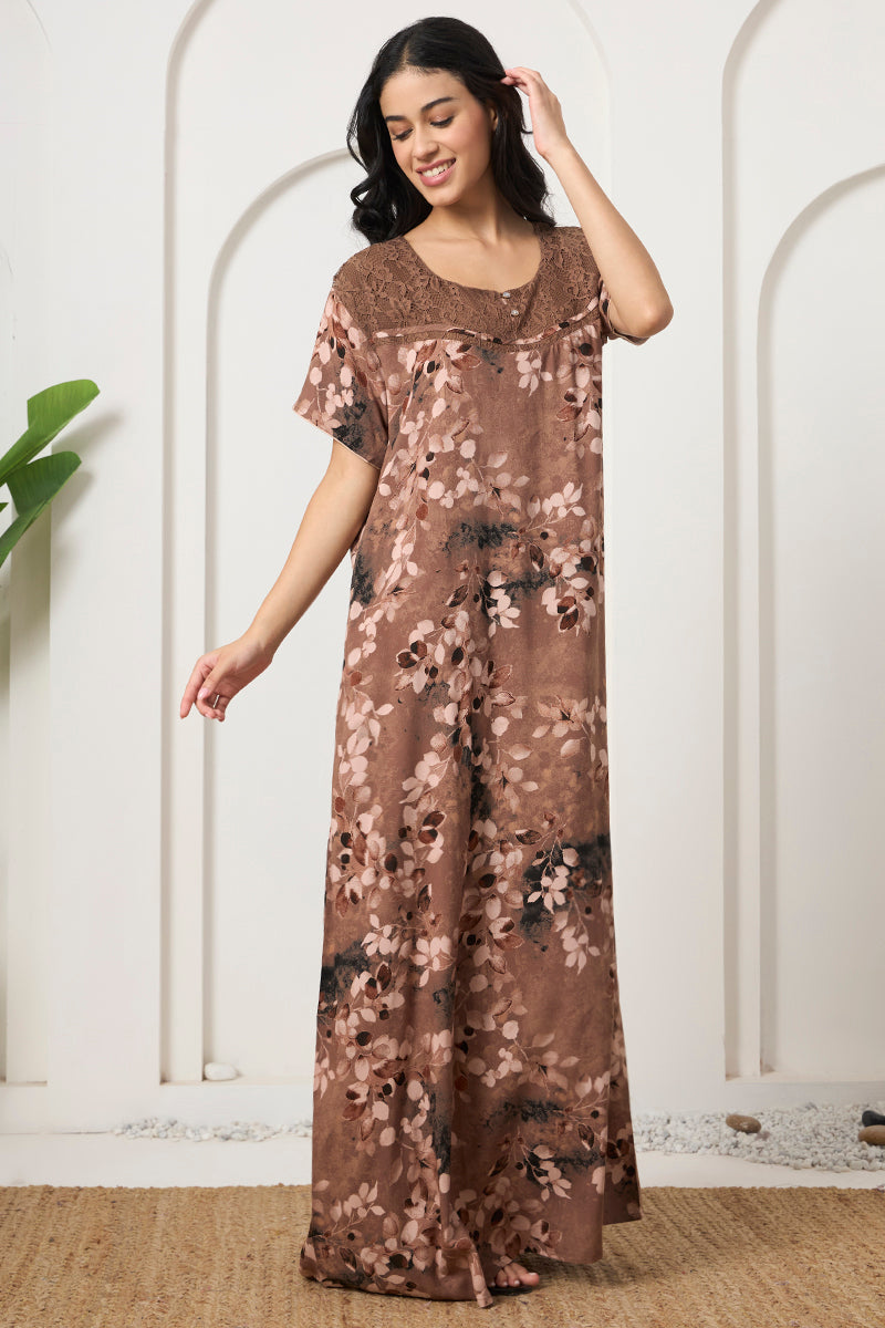 Woman standing in a brown leaf print nightgown