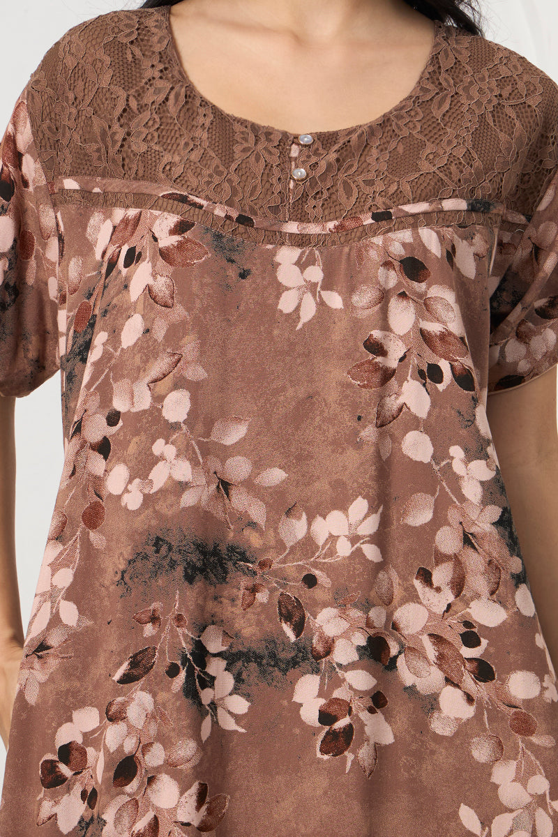 Close up of the lace yoke and button detail on the brown nightgown neckline