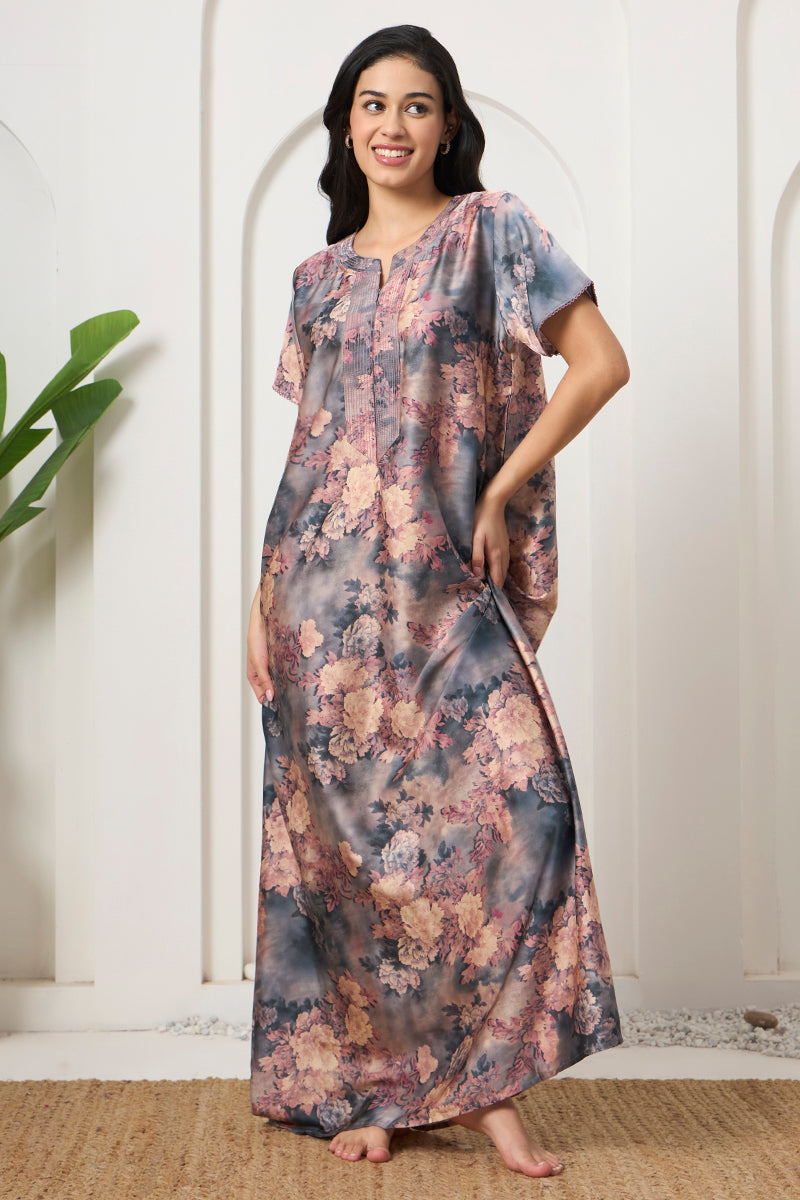 Woman smiling in a grey and pink floral tie-dye nightgown