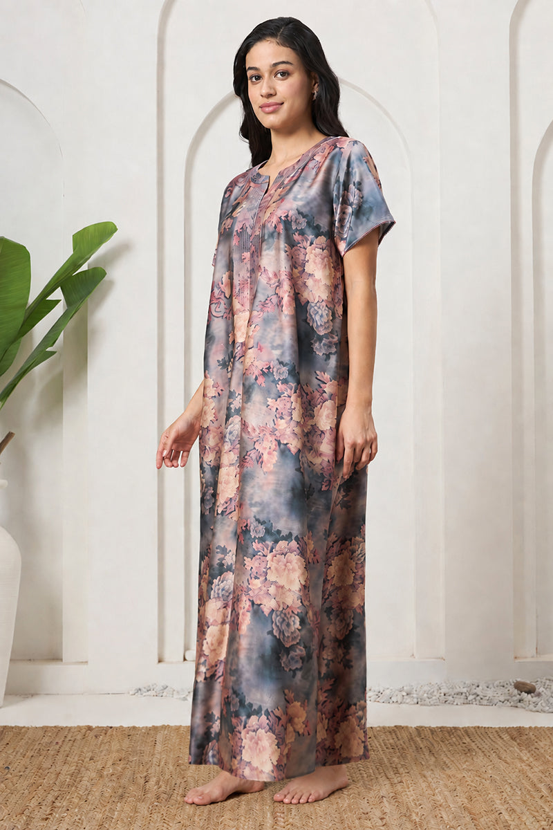 Woman posing in a grey floral tie-dye nightgown with hand relaxed