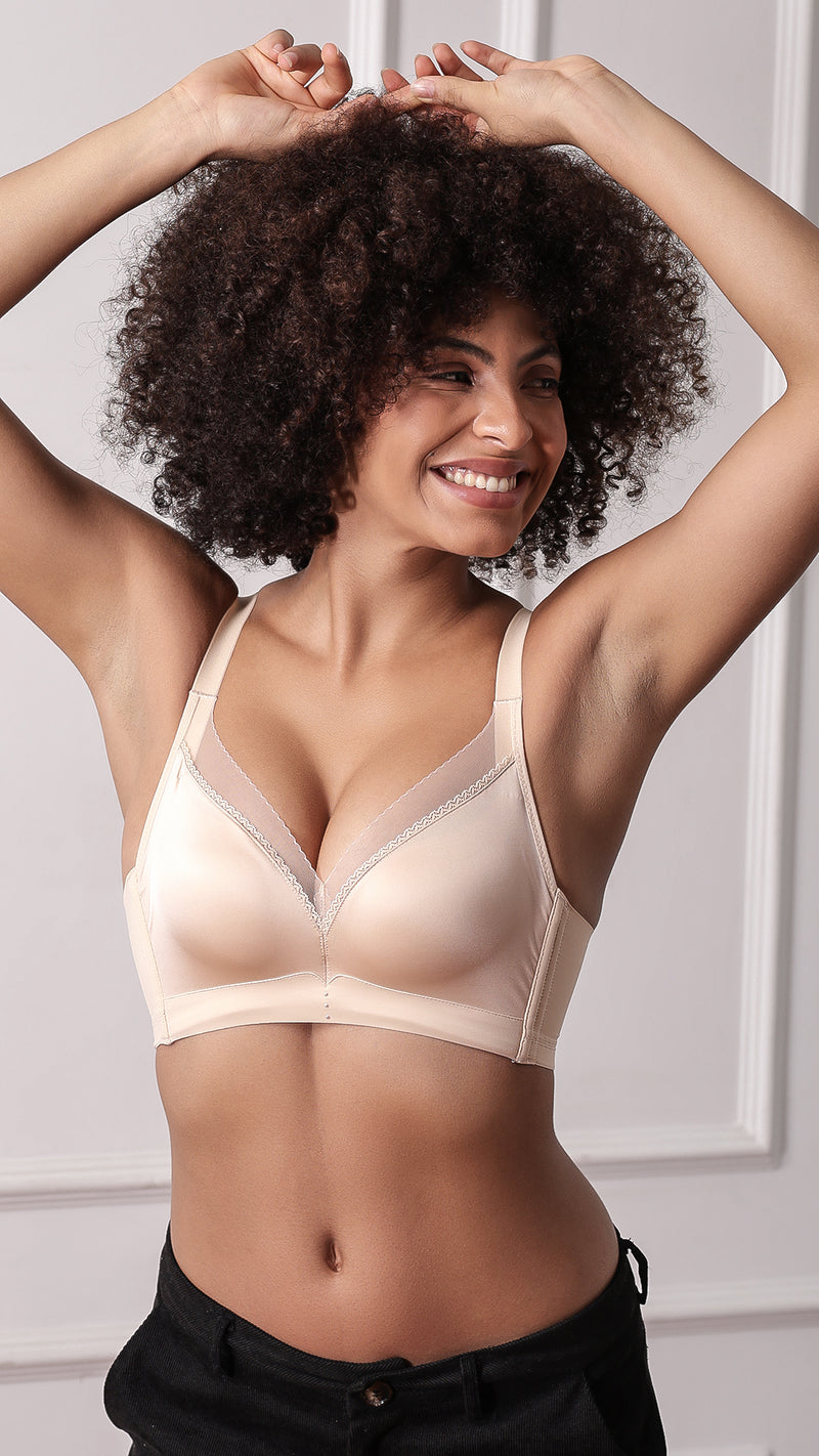 Close-up of beige T-shirt bra showing lace trim and pearl embellishment