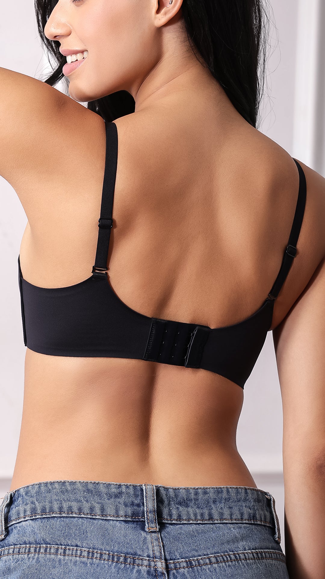 Back view of black bra showing adjustable straps and 4-hook closure