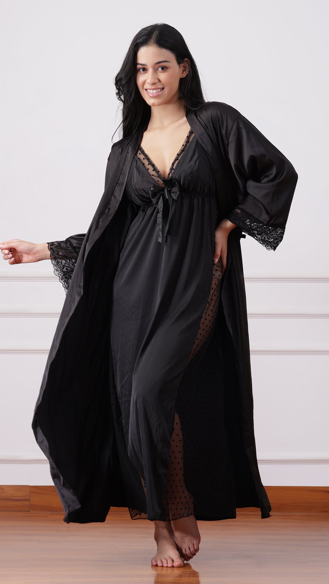 Black satin robe over long slip dress with sheer polka-dot panel, front view